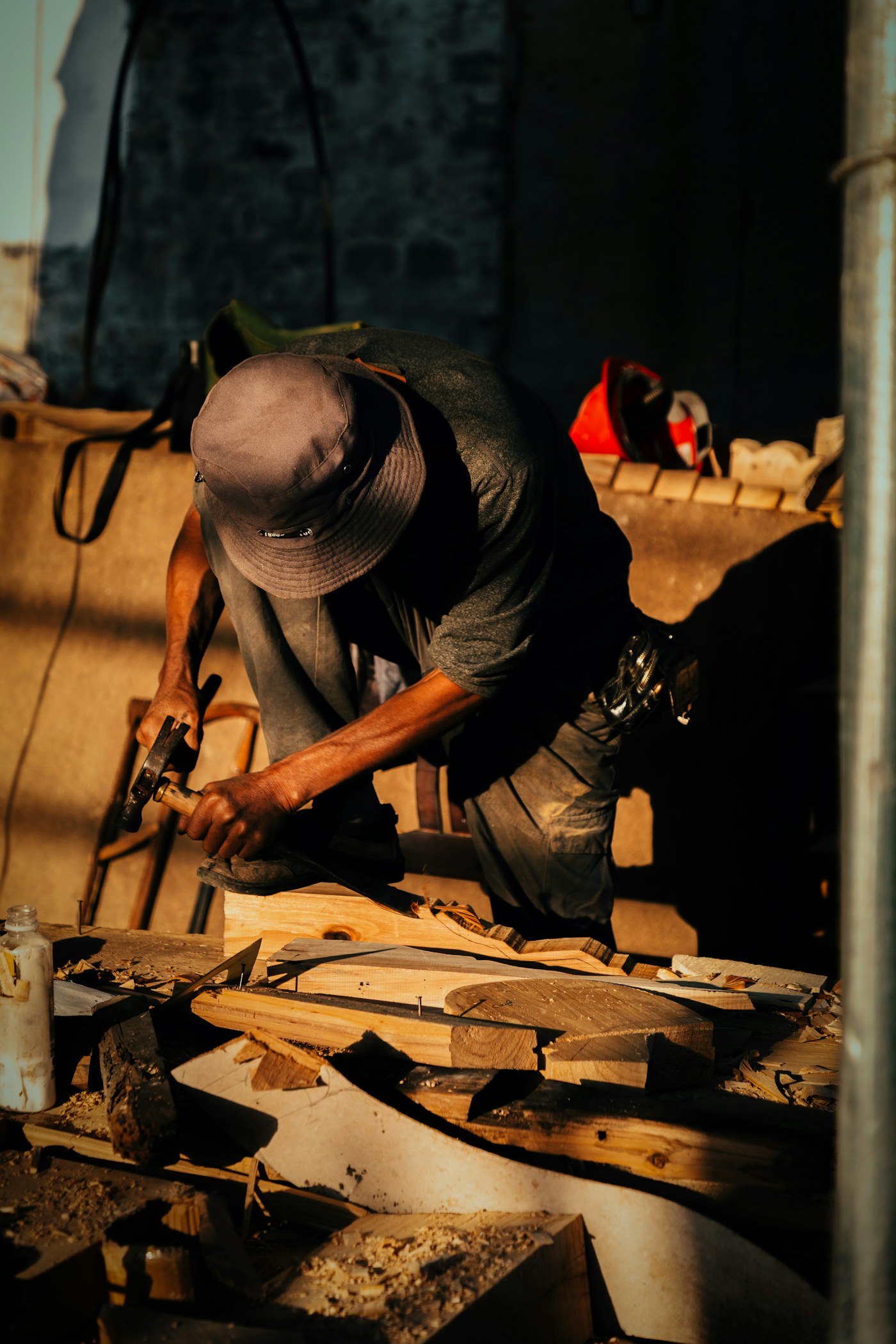 A carpenter shaping wood in a workshop